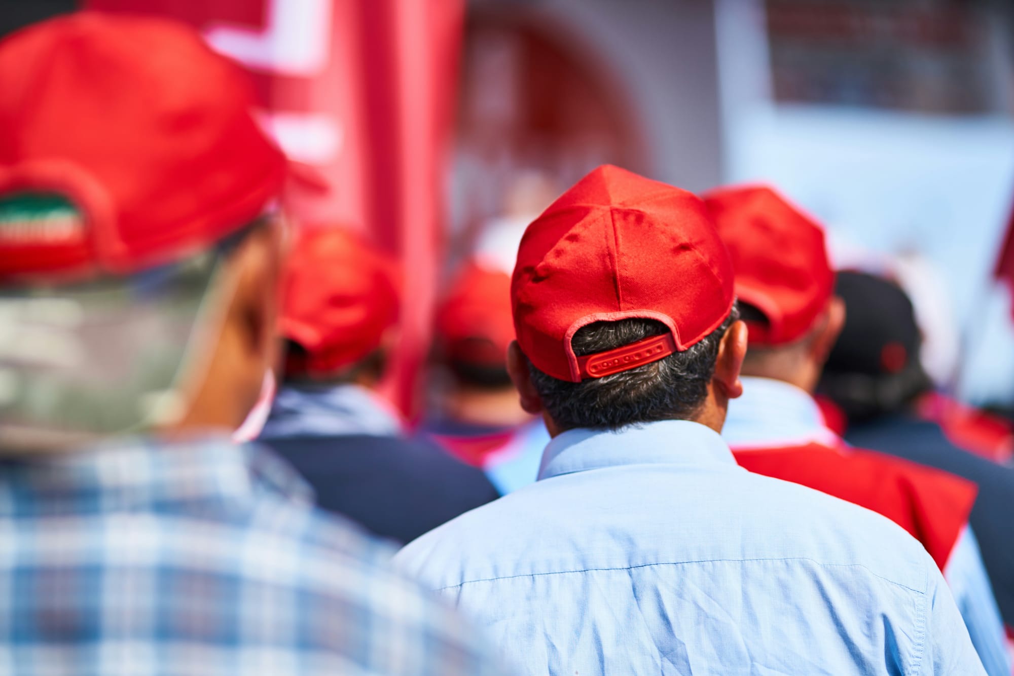 People wearing red hats, turned away