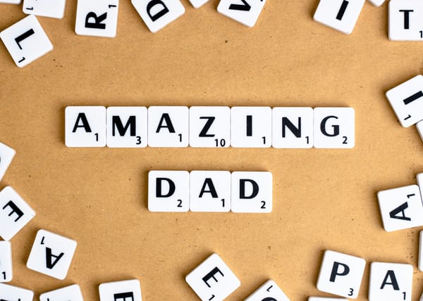 Scrabble pieces spelling out "Amazing Dad"