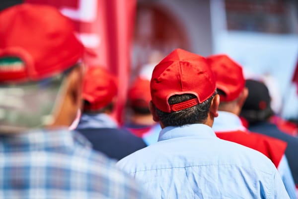 People wearing red hats, turned away